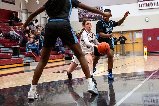 Rusty Rae/News-Register##Junior guard Bella Lopez makes a bounce pass through traffic. Lopez showed an ability to score late in games, but has led the Pirates with veteran court presence, facilitating baskets around the interior.
