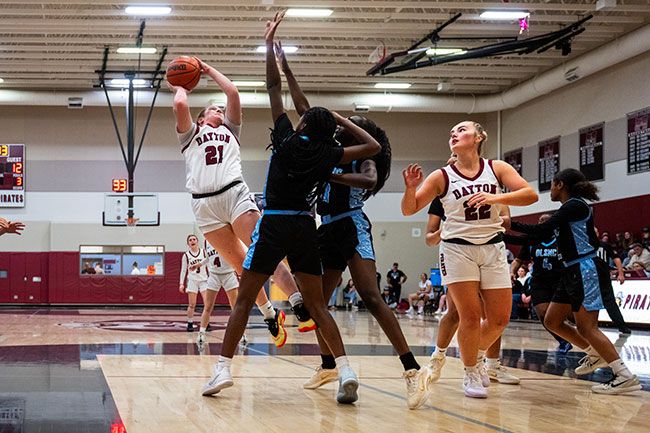 Rusty Rae/News-Register##Hadley Hughes rises over two De La Salle North Catholic defenders on Thursday, Dec. 11 inside the Dayton High School gymnasium. Hughes led Dayton as they went 3-0 at their home tournament and improved to 4-1.