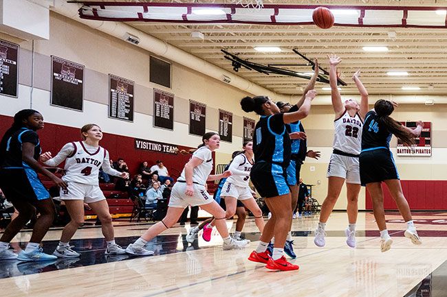 Rusty Rae/News-Register##Junior forward Charly Upmeyer shoots a short-range jumper over three De La Salle North Catholic defenders. Upmeyer scored 23 points during the Dayton Tournament while taking control of the paint.