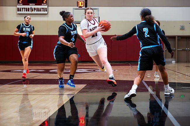Rusty Rae/News-Register##Junior forward Hadley Hughes barrels toward the basket during the Pirates 53-45 victory over De La Salle North Catholic on Thursday, Dec. 11. Hughes put up 24 points in the contest, and went on to score another 31 points in Dayton&rsquo;s next two games at the Dayton Tournament from Dec. 11-13. Hughes was giving her best effort just days after the passing of her father.