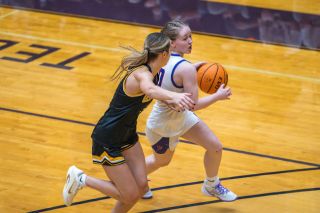 Rusty Rae/News-Register file photo##Linfield senior guard Amelia Solt dribbles around pressure during the &lsquo;Cats game against the University of Wisconsin-Oshkosh on Friday, Dec. 3. Solt won NWC Player of the Week for Dec. 8-14 for her performances in victories versus Simpson and Corban.