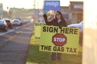 Rachel Thompson/ News-Register##Debbie Phillips of Yamhill waves at cars passing on Highway 99W in McMinnville last month, hoping drivers will take the opportunity to stop.