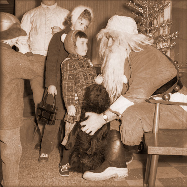 ##(Dec. 16, 1960) An unidentified black dog again this year made his appearance to visit Santa Claus in McMinnville to steal candy and possibly crowd in ahead of a few of the visiting children. Santa said that the dog has appeared annually for the past five or six years to catch pieces of candy dropped by youngsters. He gets more grouchy each year, Santa said.