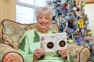 Rachel Thompson/News-Register##Nancy Rotunno of McMinnville makes about 60 Christmas cards by hand each year to send to friends and relatives. A retired educator, she loves crafting. She also created most of the ornaments on her tree. This year, she chose blue and white for the interior of her annual homemade Christmas card (below). When the card is opened, the center section pops out, making it three-dimensional.