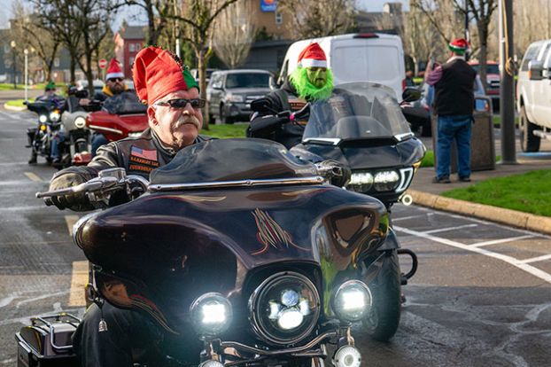 Rusty Rae/News-Register##Dave Stevens, founder of BC Harleys drag racing group, rolls up to the hospital with other members of the organization Friday afternoon. The riders roared through downtown McMinnville on their way to deliver Christmas gifts.