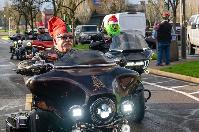 Rusty Rae/News-Register##Dave Stevens, founder of BC Harleys drag racing group, rolls up to the hospital with other members of the organization Friday afternoon. The riders roared through downtown McMinnville on their way to deliver Christmas gifts.