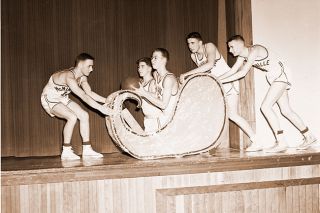 ##(Dec. 23, 1955) Hoping to ride in with a Christmas gift for their coach in the form of a victory over Albany tonight, are these members of coach Eldore Baisch&rsquo;s junior varsity team at McMinnville High. Pulling the sleigh on the left is Jack Carey, while Mike McPhillips and Mike Mattecheck are pushing from behind. Riding along with the basketball are Tommy Miller and Don Carlson.