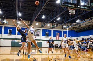 Rachel Thompson/
News-Register##Senior guard Haley Miersma gets the shot off over the outstretched arms of Grants Pass forward Eva Lindahl during Sunday&rsquo;s matchup at the Capitol City Classic. Miersma scored eight of her 10 points in the second quarter to help Amity build a comfortable lead against the 6A opponent. She was named player of the game.