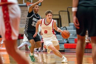 Rusty Rae/News-Register##Senior Dylan Ferrua pushes the ball up the court around an Ida B. Wells defender during Mac&rsquo;s nonleague game on Friday, Dec. 19.