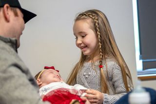 Rusty Rae/News-Register##Maisie Staebler visits with baby Mallory, 3 months, held by their dad, Cody Staebler. Maisie is a cancer survivor, a dancer and a preschooler &mdash; but she may be proudest of her new title, big sister.