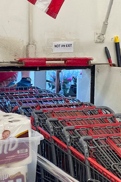 Kirby Neumann-Rea/News-Register##Paper sign taped inside Bi-Mart makes it clear: Don&rsquo;t stoop to exit here.