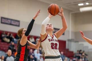 Rusty Rae/News-Register##Pirates&rsquo; junior forward Charly Upmeyer shoots from under the rim while Willamina&rsquo;s Bridgette Manley attempts to block the shot during the team s battle on Jan. 7 at Dayton High School.