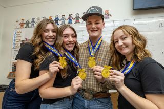 Rachel Thompson/News-Register##Madi Gregor, Peyton Gregor, Tucker VanDyke and Saige Hinckley show the medals they brought home to Yamhill Carlton High School after winning the national Agricultural Sales competition this fall at the FFA convention that attracted competitors from all 50 states. Madi, who graduated from YC in June 2025, also placed third in the nation individually, and Tucker, a current senior like his other teammates, placed fourth. They credited their national title to teamwork, hard work and support from their coaches, community and alumni.