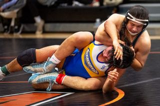 Rusty Rae/News-Register##Mahiashlok Eaglepipe of Willamina wraps up Angel Cortes of Gervais, eventually winning via 16-10 decision and moving on to place second in the 190-pound weight class.