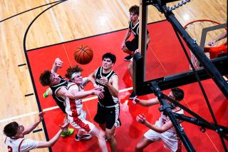 Rusty Rae/News-Register##Mac&rsquo;s Cayd Howard fights for positioning in the paint as the ball falls to Earth following a shot in the Grizzlies home loss to Sherwood on Friday, Jan. 16.