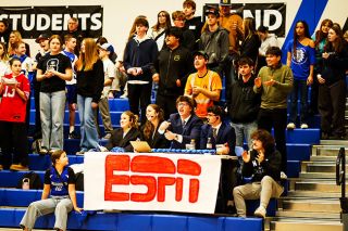 Rachel Thompson/News-Register## From left to right &mdash; Amity students Bailey Anderson, Carrie Sims, Paden Berkey and Jackson Walker man a faux ESPN sports desk in the Warriors student section. The sportscasters held up signs that read &ldquo;LET&rsquo;S GO WARRIORS,&rdquo; &ldquo;AIRBALL,&rdquo; and &ldquo;ANOTHA W!&rdquo; to name a few, and produced commentary on the game.