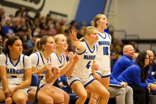 Rachel Thompson/News-Register##From left to right &mdash; Eliza Nisly, Kylie Wilson, Haley Miersma and Adie Nisly jump out of their seats as the Warriors second unit puts on a show in the final period of their victory over Dayton in the Warrior Gymnasium on Friday, Jan. 16.