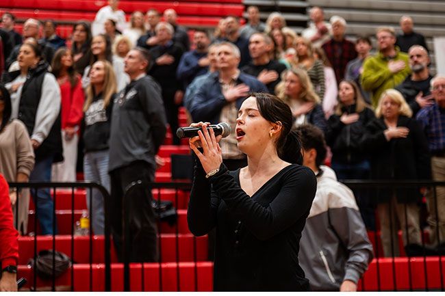 Rusty Rae/News-Register##McMinnville High School senior MJ Milam hits an emotional note in &ldquo;The Star-Spangled Banner&rdquo; as she sings for the opening of the Grizzly boys&rsquo; basketball game Friday night. A member of the Twilighters, she enjoys taking her turn performing the national anthem.