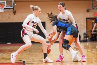 Rusty Rae/News-Register##Grizzlies&rsquo; junior guards Taylor Terry (left) and Mabel Findley (right) steal the ball away from senior Newberg guard Kuenzi Blubaugh in a full court press during Mac&rsquo;s victory over the Tigers on Tuesday, Jan. 20, in the MHS gymnasium. Mac forced 18 steals in the game.