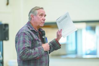 Rusty Rae/News-Register##During his town hall in the McMinnville National Guard Armory Thursday, U.S. Sen. Jeff Merkley, D-Oregon, holds up his new publication, &ldquo;The Ten Rules of Trump&rsquo;s Authoritarian Playbook.&rdquo; Merkley told a crowd of about 200 that he is concerned about our country. He also will be issuing a booklet about 10 things citizens can do in response, such as peacefully protest and vote.
