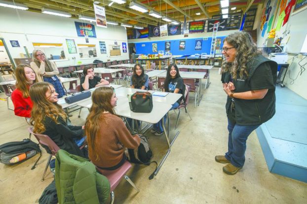 Rachel Thompson/News-Register##Patton Middle School STEM teacher Michele Reschly, right, congratulates the Space Whale team of students who were chosen to create an experiment for NASA Flights. Students, seated clockwise from bottom center, include Addie Patton, Miriam Schultz, Eleanora Bent, Joss Dossey, Leslie Grimaldo and Aimee Contreras. Assistant Principal Lisa Jordan-Zornow stands at left.