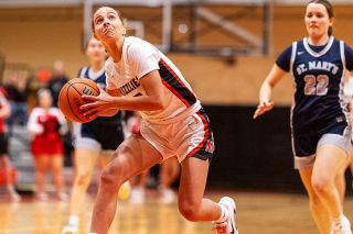 Rachel Thompson/News-Register file photo##Mac freshman guard Cameron Baker keeps a low center of gravity as she drives to the hoop with conviction in the Grizzlies&rsquo; 61-40 victory over St. Mary&rsquo;s Academy on Jan. 6, in the MHS gymnasium. Baker received increased minutes at the season&rsquo;s start while filling in for an injured Alex Bates. Since then, Baker has thrived as a sixth-man off the bench, providing a spark of aggressiveness to the Grizzlies&rsquo; capabilities on both slides of the ball.