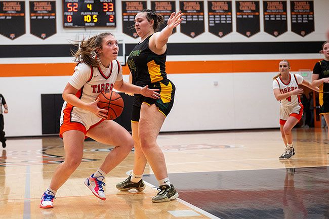 Rusty Rae/News-Register file photo##YC senior forward Peyton Gregor drives past May Jimenez-Acosta from Gaston during the Tigers&rsquo; 54-37 beating of the Greyhounds on Dec. 5, 2025, at the Tiger Dome. YC is undefeated at home as of Jan. 26.