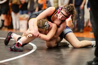 Rachel Thompson/News-Register##Yamhill Carlton&rsquo;s Addison Tuning gets the better of Banks freshman Madison Turner during their dual in the 155-pound championship at the Girls Golden Yam Challenge on Jan. 24 at Yamhill Carlton High School. Tuning ultimately fell via 6-0 decision to Turner, but left the Tiger Dome all smiles after helping the Tigers win team gold.