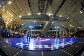 Rusty Rae/News-Register##Under the tail of the Spruce Goose at Evergreen Aviation and Space Museum on Friday, Jan. 23, Linfield freshman Damon Gasilos works to pin his opponent from Treasure Valley Community College. Gasilos was successful, along with many Wildcats who roared to victory with the power of a jet engine.