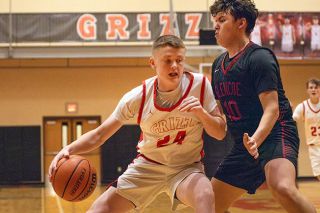 Nathan Ecker/News-Register##Mac freshman Colby Frank shows no fear on his way to the hoop, bodying Glencoe senior Manuel Alvarez Romero. Frank helped the Grizzlies find their first win in three weeks with his strength in the paint.