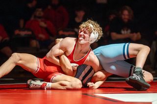 Rachel Thompson/News-Register## McMinnville&rsquo;s Trent Rauch plays to the Grizzlies student section with a spicy smirk as he pins Liberty&rsquo;s Gabriel Farias during Mat Madness on Thursday, Jan. 22. Rauch forced Farias to the mat with two seconds left in the first period.