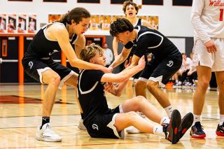 Nathan Ecker/News-Register##Dayton&rsquo;s Jax Brandon-Sanchez, left, and Riley Corona, right, help Jaxon Allen off the ground after tumbling backwards on a curling hook shot over Willamina&rsquo;s Austin Verdino. Allen was fouled and made the free throw to take an intermittent one-point lead in the closing minutes of the Pirates and Bulldogs rivalry matchup in Willamina on Friday, Jan. 30.