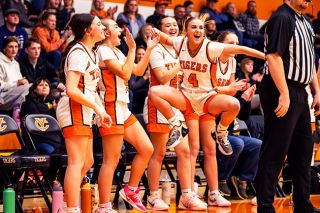 Nathan Ecker/News-Register##Yamhill Carlton junior Josie Barker, No. 4, and the Tigers bench celebrate a tough shot made in the paint by Lilah Stahl. The Tigers&rsquo; energy from players on and off the court helped them reclaim their spark in a key Coastal Range League victory over Neah-Kah-Nie on Thursday, Jan. 29 at the Tiger Dome.