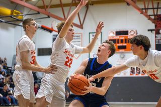 Nathan Ecker/News-Register##Ethan Owings, a former Bulldog, fights toward the basket through the outstretched arms of multiple Willamina defenders during Amity&rsquo;s victory in the West Valley on Wednesday, Feb. 4.