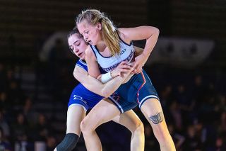 Rachel Thompson/News-Register##Zoe Brewer and Jessica Cottings battle for positioning, staying on their feet during their bout in Ted Wilson Gymnasium on Friday, Jan. 30.