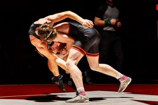 Rachel Thompson/News-Register##Grizzly junior Andrew Morgan gets Sherwood&rsquo;s Evan Karl off his feet, sending him to the mat for a takedown during a dual at McMinnville High School on Thursday, Feb. 5. Morgan dominated Karl in every respect, scoring three takedowns and winning by 17-2 technical fall.