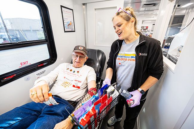 Rachel Thompson/News-Register##Just after giving blood, Walter Wierenga chooses a snack from Sheri West, collection specialist and driver, in the American Red Cross bloodmobile parked at Golden Valley Brewery on Friday. The longtime donor said he never has a problem with feeling faint.