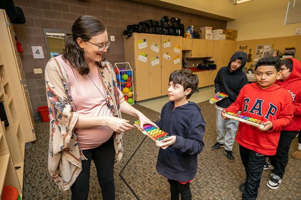 Rachel Thompson/News-Register##Newby Elementary School music teacher Sarah Barr collects a glockenspiel from fifth-grader Rhea Skinner at the end of music class Thursday. The instruments were purchased with a $1,000 grant from the McMinnville Education Foundation to support music literacy instruction. Following in line are Julian Diaz, Isaiah Bechtol-Ramirez and Andrew Garcia.
