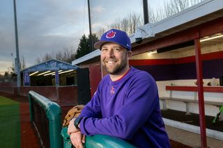 Rusty Rae/News-Register##Jordan Harlow stands under the bright lights of Roy Helser Field while in the home dugout.