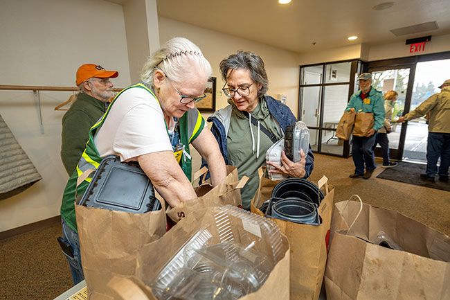 Rachel Thompson/News-Register##Volunteer Carol Paddock, left, assists Susan Escure of McMinnville in sorting plastic containers during The Great Plastic Roundup on Saturday at McMinnville Covenant Church.