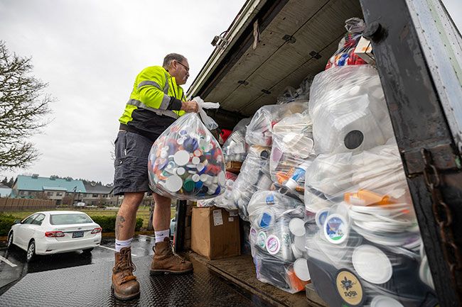 Rachel Thompson/News-Register##Todd Niehus, a commercial front-load driver for Recology, loads bags of hard-to-recycle plastics into a truck. White called the 14th collection event a &ldquo;record breaker,&rdquo; with more than 1,500 pounds of plastic gathered by 60 volunteers. The event, sponsored by Zero Waste McMinnville, collected plastics excluded from curbside recycling for $4 per full grocery bag.