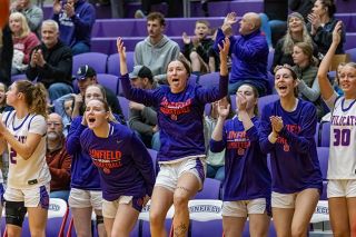Nathan Ecker/News-Register##Linfield senior Logan Roberts and the rest of the Wildcats&rsquo; bench get excited for a basket made during the second half of their victory over Puget Sound. The bench&rsquo;s energy was key to helping Linfield claw back.