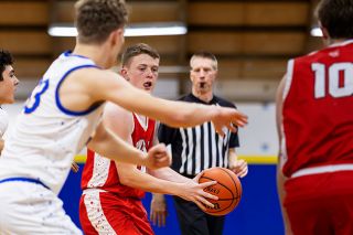 Nathan Ecker/News-Register##Colby Frank dishes a pass into the paint during the Grizzlies loss at Newberg on Friday, Feb. 13. Frank was second on the team with seven points, continuing to show offensive and defensive progression with another start in the lineup.