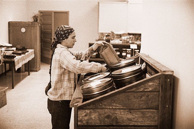 ##(Feb. 18, 1976) A customer at Yamhill Valley Foods serves herself from bins containing flour and grains. The nonprofit food cooperative at Third and Galloway streets in McMinnville depends on volunteer labor from its own customers to maintain the store and order supplies. Coop members benefit from a discount, and membership is open to everyone.