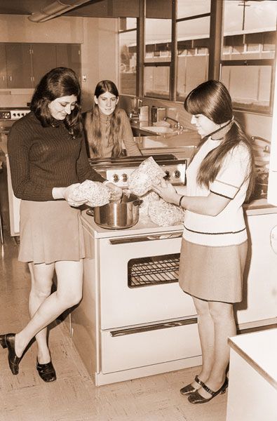 ##(Feb. 20, 1971) Chicken and noodles go together so the McMinnville Soroptimist Club members make a chicken and noodle dinner an annual affair as a means of raising funds for sponsoring an American Field Service foreign student. Liliana Fricker, AFS student from Argentina, is shown the art of noodle cooking by Marsha Wright, a daughter of her American family. Melissa Birch, who lived in Paraguay during July and August of last year, watches the process.