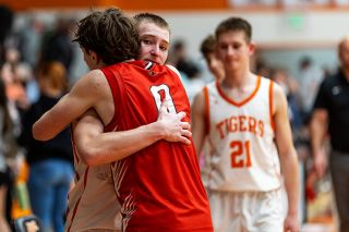 Rachel Thompson/News-Register##YC sophomore guard Dylan Thielke and Corbett junior guard Armin Mehanovic embrace following their tightly contested Coastal Range League championship game on Saturday, Feb. 21, at the Tiger Dome.