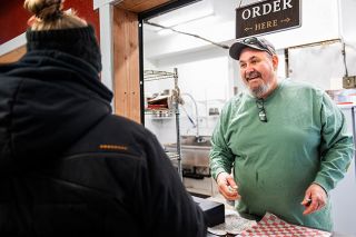 Rusty Rae/News-Register##Bert&rsquo;s Chuckwagon owner Richard Bert greets a customer at his newly opened location &mdash; Cowboy Kitchen &mdash; at DeLashmutt Arena at the Yamhill County Fairgrounds. He&rsquo;s serving burgers, hot dogs and breakfast foods with plans to add more items to the menu.