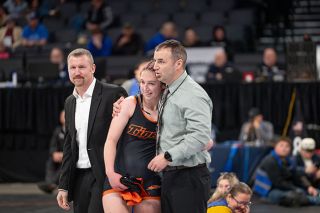 Rusty Rae/News-Register## Addison Tuning is consoled by her father and YC assistant coach Billy Tuning after falling in the 4A/3A/2A/1A 155-pound championship to place second. It was not how Tuning wanted to end, but even in defeat she became the first girls state placer in Tiger history.