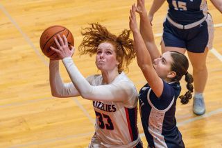 Nathan Ecker/News-Register##Senior forward Brooklynn Summers rises to the hoop in the Grizzlies  77-24 victory over Liberty on Feb. 26.