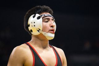 Nathan Ecker/News-Register##Nelson Campos prepares for treatment on his split bottom lip during his match versus Century&rsquo;s Samuel Gomez at the 6A wrestling championships in Veterans Memorial Coliseum on Feb. 28. Campos needed face wraps and treatment in nearly every match for the wound suffered in his second of five bouts on the day. In the aftermath, general body pain outweighed the toll taken to his face.